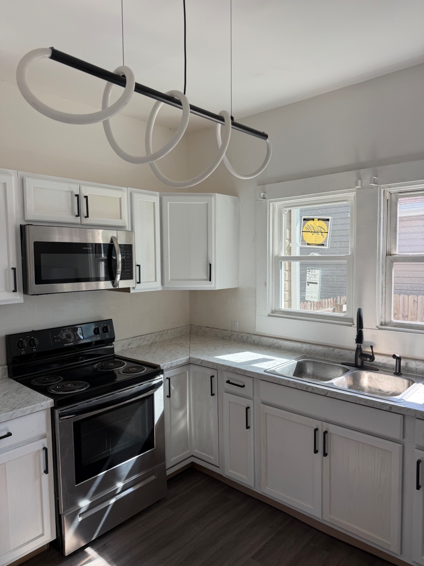 Modern kitchen remodel with white cabinets and gold hardware by TrustBridge Construction